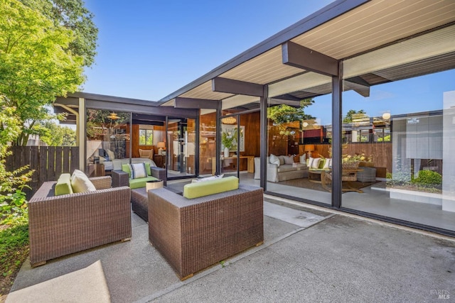view of patio with an outdoor hangout area and fence