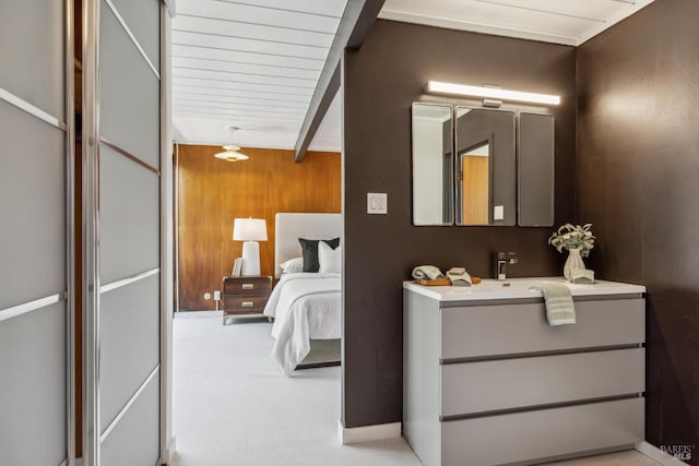 carpeted bedroom with wood walls