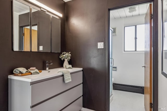 bathroom with a baseboard heating unit, tile patterned floors, and vanity