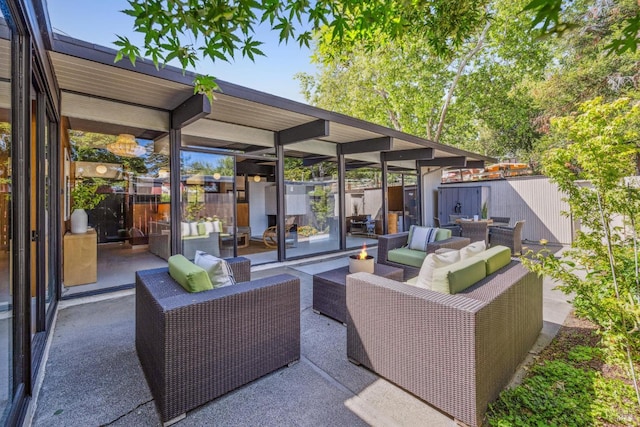 view of patio / terrace featuring an outdoor hangout area and fence