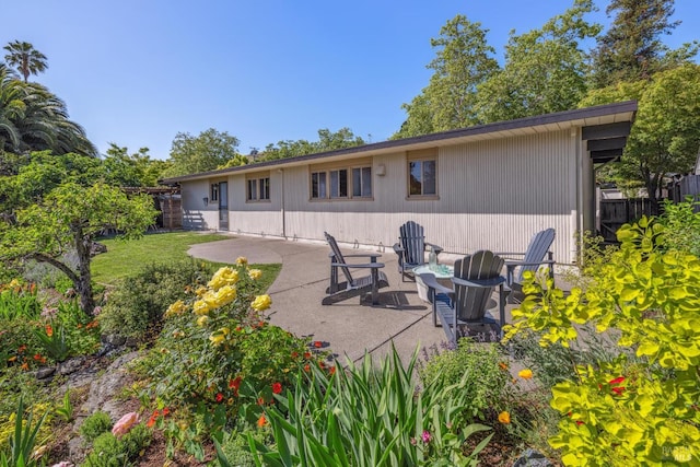 rear view of property featuring a patio area and fence