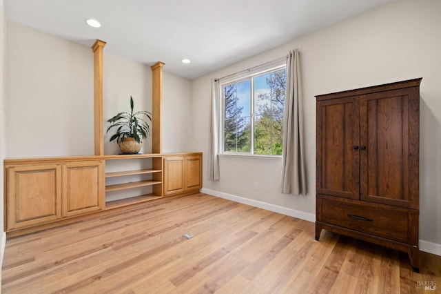 interior space featuring baseboards, recessed lighting, and light wood finished floors