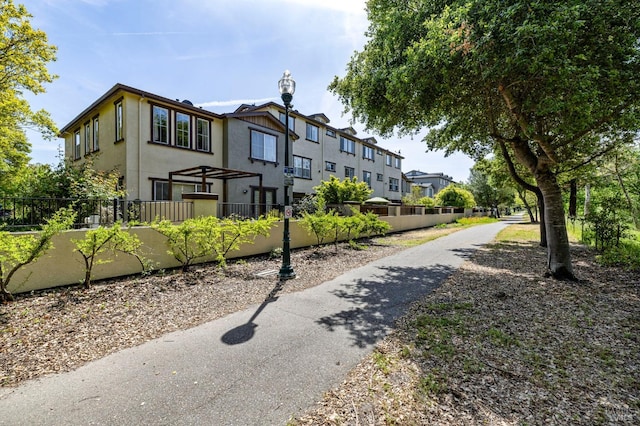 view of property's community with a residential view and a fenced front yard