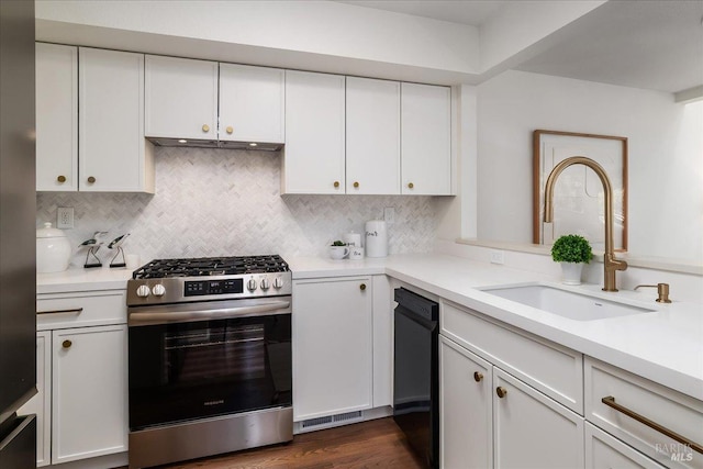 kitchen featuring a sink, light countertops, stainless steel gas range oven, and black dishwasher