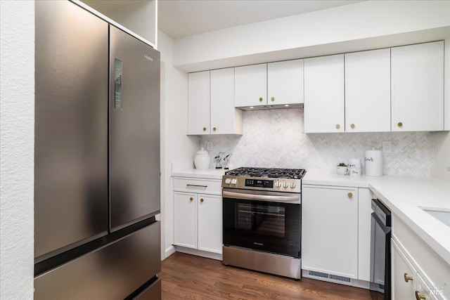 kitchen featuring light countertops, white cabinets, backsplash, and stainless steel appliances