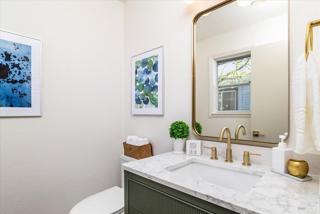 bathroom with toilet and vanity