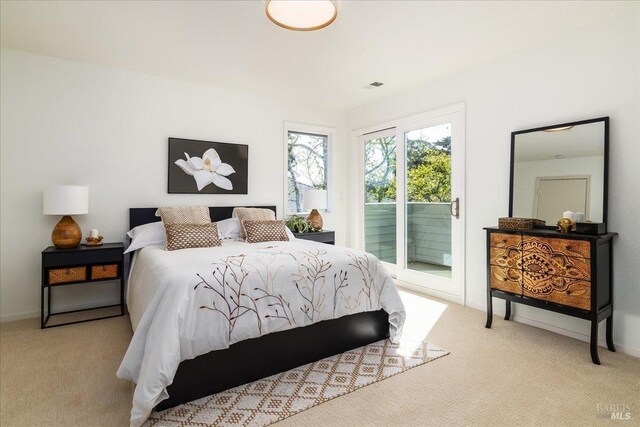 bedroom with carpet floors, visible vents, baseboards, and access to exterior