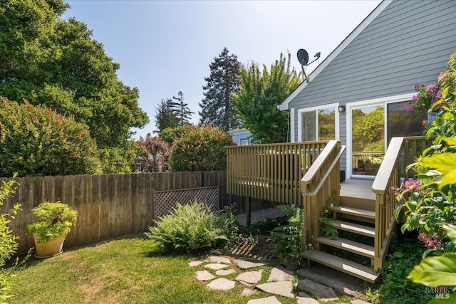 view of yard featuring stairs, fence, and a deck