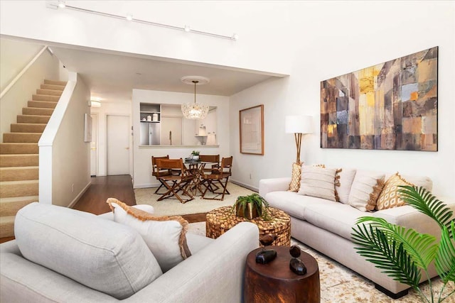 living room featuring stairway and baseboards