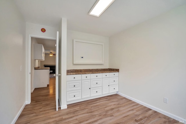 interior space with light wood-style floors and baseboards