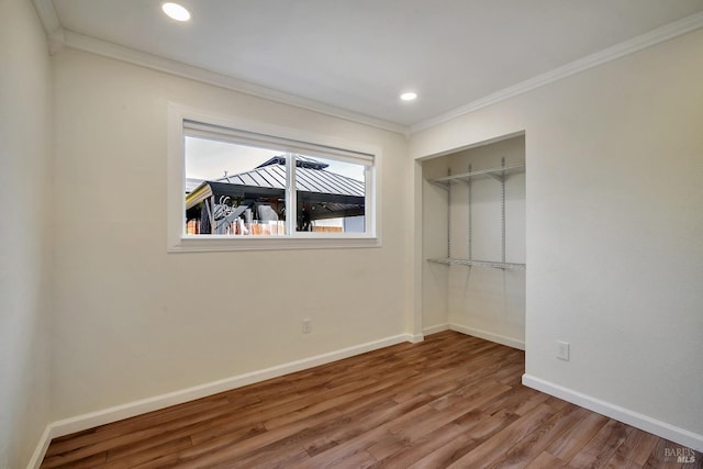 unfurnished bedroom featuring crown molding, baseboards, recessed lighting, and wood finished floors