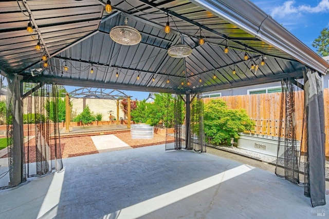 view of patio / terrace featuring a gazebo and fence
