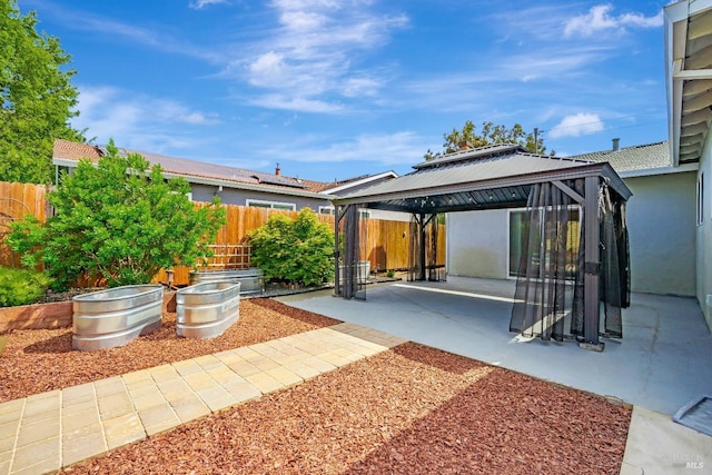 view of patio featuring a fenced backyard and a gazebo