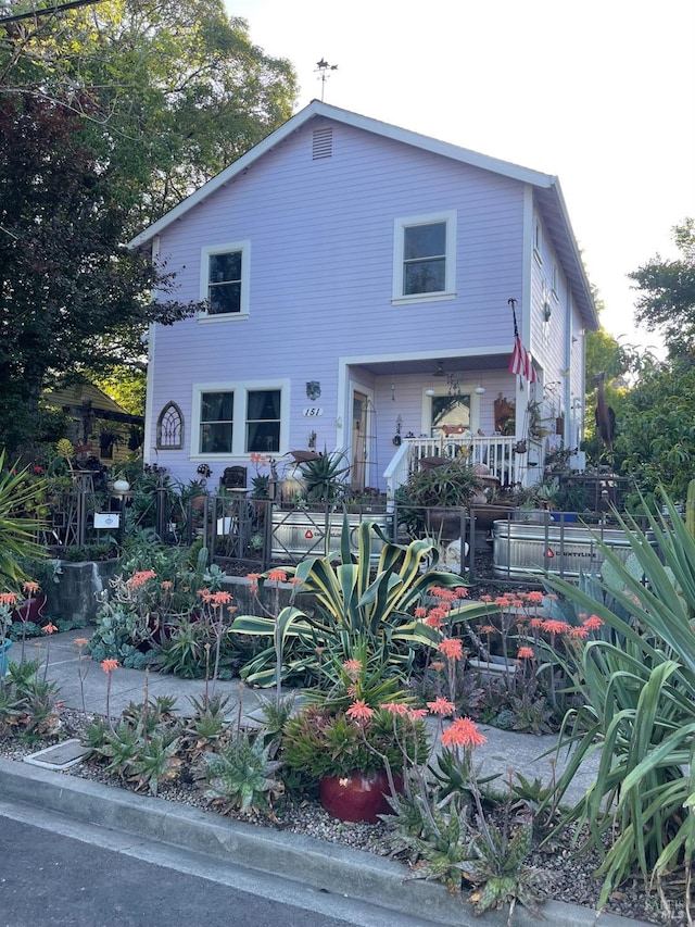view of front of property featuring fence