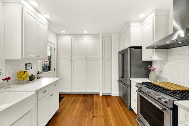 151 Randolph St, Napa, CA 94559 - kitchen featuring white cabinetry, wall chimney range hood, light countertops, and appliances with stainless steel finishes