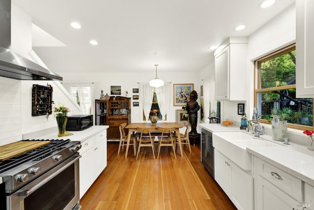 151 Randolph St, Napa, CA 94559 - kitchen featuring wall chimney range hood, appliances with stainless steel finishes, light countertops, and a healthy amount of sunlight