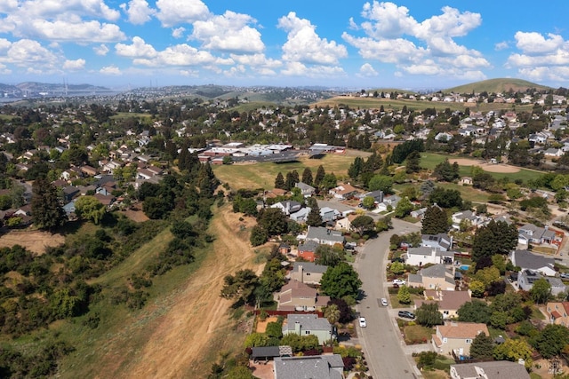 drone / aerial view featuring a residential view and a mountain view