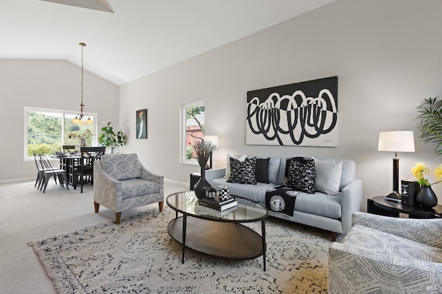 living room featuring plenty of natural light, carpet flooring, baseboards, and lofted ceiling