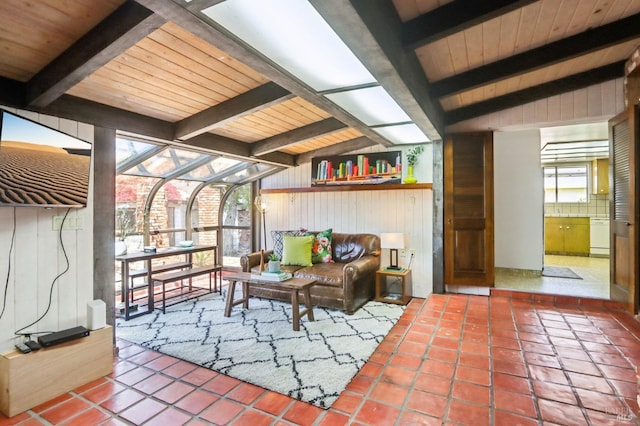 interior space featuring wood walls, lofted ceiling with beams, wood ceiling, and tile patterned flooring