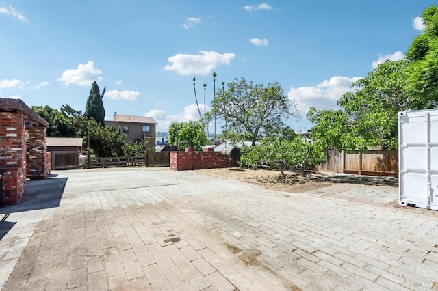 view of road with decorative driveway