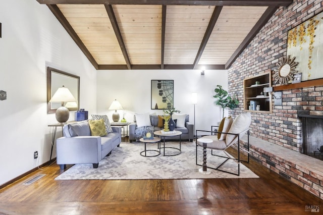 living room with baseboards, vaulted ceiling with beams, hardwood / wood-style floors, and visible vents