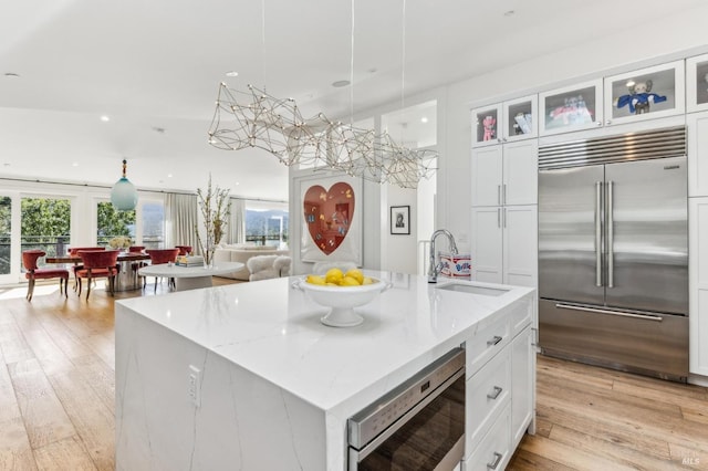 30 Corte Sereno, Greenbrae, CA 94904 - kitchen with built in appliances, a sink, recessed lighting, light wood-type flooring, and white cabinetry
