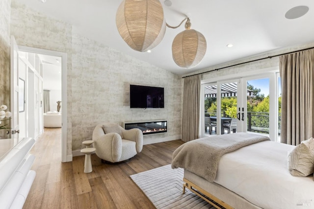 30 Corte Sereno, Greenbrae, CA 94904 - bedroom featuring access to outside, wood finished floors, a glass covered fireplace, and baseboards