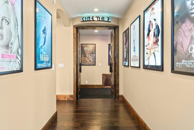 hall featuring recessed lighting, baseboards, hardwood / wood-style flooring, and arched walkways