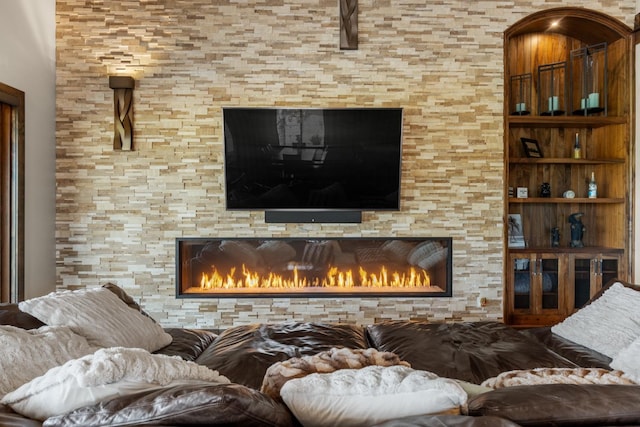 living room featuring a glass covered fireplace