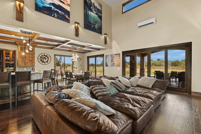 living room with beam ceiling, a wall mounted air conditioner, dark wood-style floors, a notable chandelier, and coffered ceiling