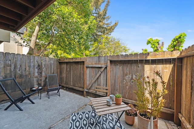 view of patio featuring a gate and fence