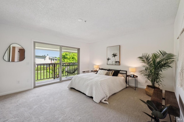 bedroom with access to outside, a textured ceiling, carpet, and baseboards