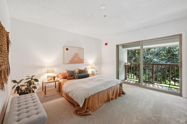 carpeted bedroom featuring access to outside and a textured ceiling