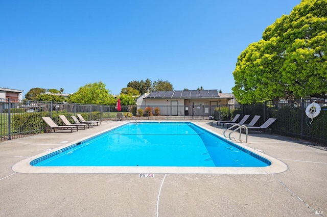 pool featuring fence and a patio