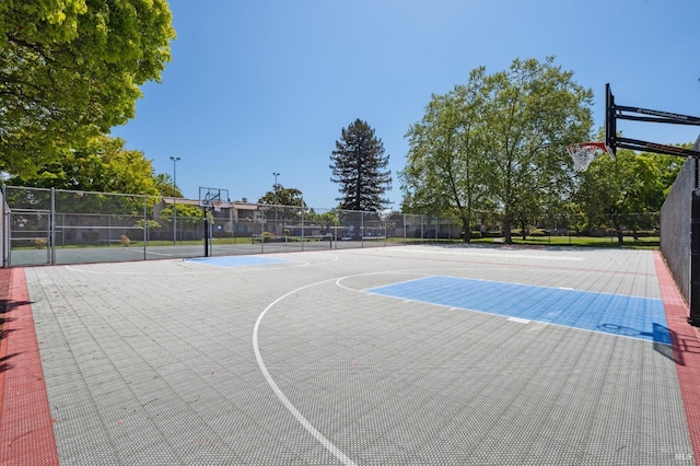 view of basketball court featuring fence and community basketball court