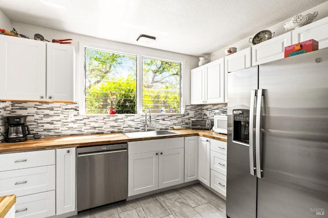 1722 Elm St, Napa, CA 94559 - kitchen with appliances with stainless steel finishes, wooden counters, a sink, and decorative backsplash