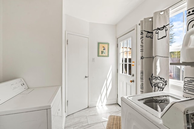washroom with laundry area, washing machine and dryer, and marble finish floor