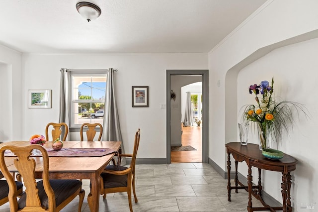 1722 Elm St, Napa, CA 94559 - dining space featuring arched walkways, baseboards, ornamental molding, and light marble finish floors