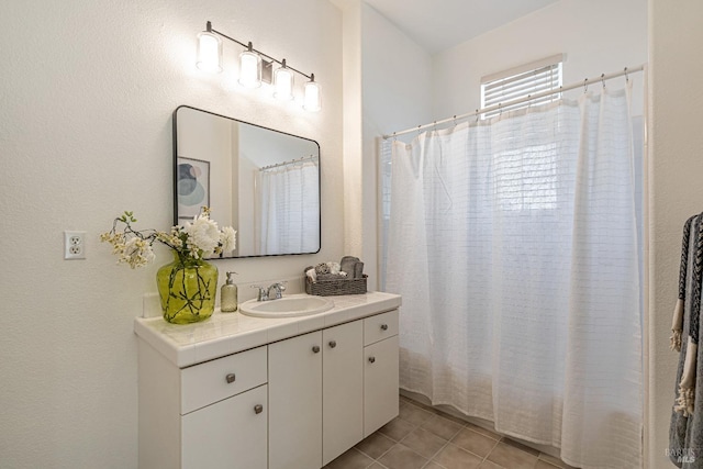 full bathroom with vanity, tile patterned floors, and curtained shower