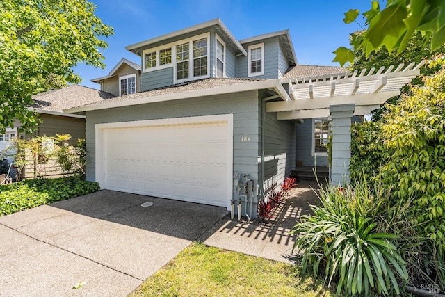 view of front of property with concrete driveway, a pergola, and a garage