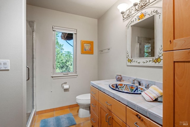 full bath with vanity, a stall shower, tile patterned floors, and toilet