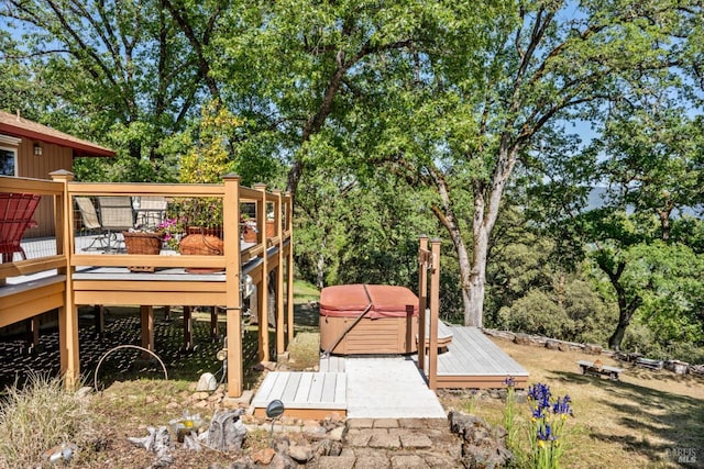 wooden deck with a hot tub