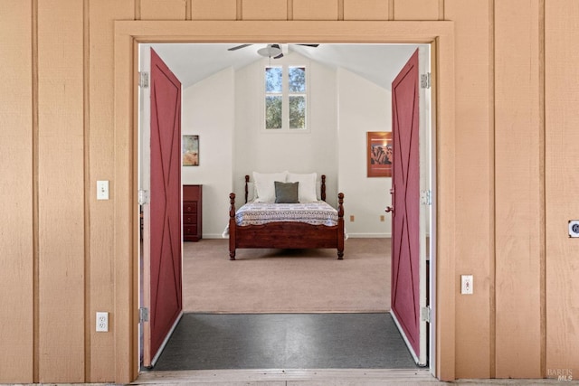 bedroom with baseboards, carpet, and lofted ceiling