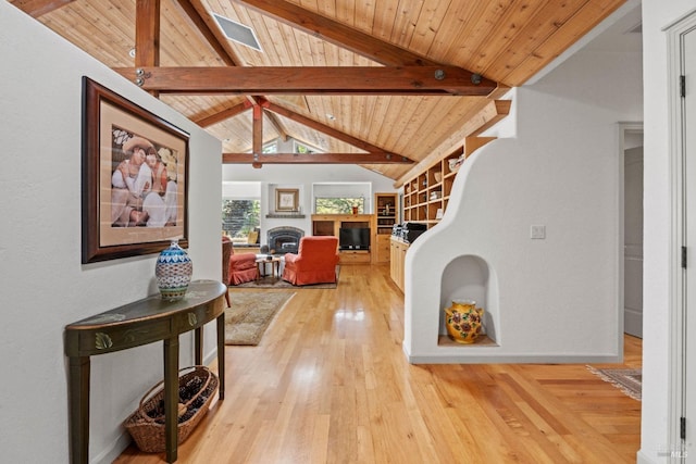 hallway with vaulted ceiling with beams, light wood finished floors, and wooden ceiling