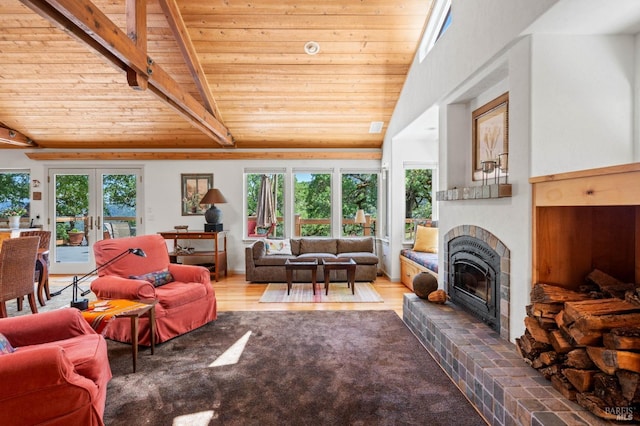 carpeted living area featuring lofted ceiling with beams, wood ceiling, and a fireplace