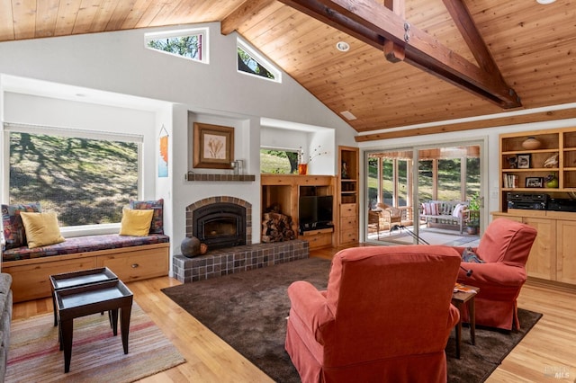 living room featuring plenty of natural light, light wood-style flooring, and wood ceiling