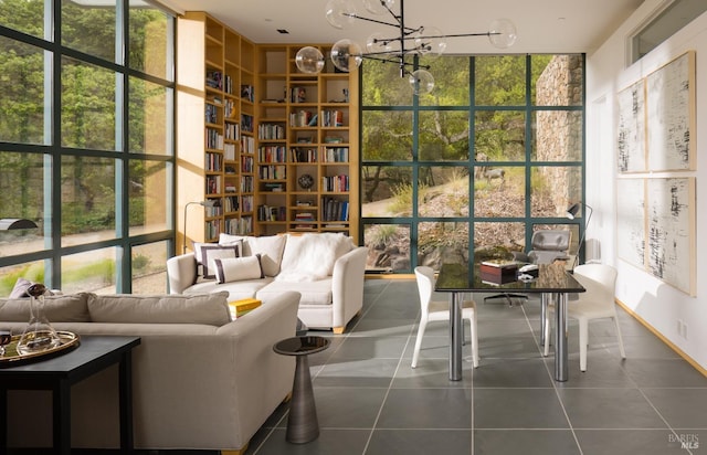 sunroom / solarium with a healthy amount of sunlight and a notable chandelier