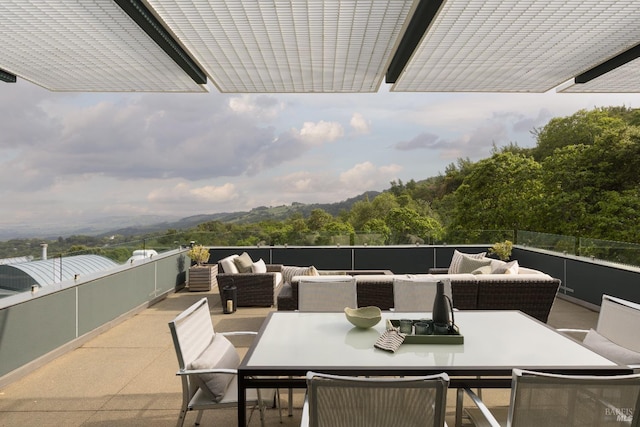 balcony with an outdoor living space and outdoor dining space