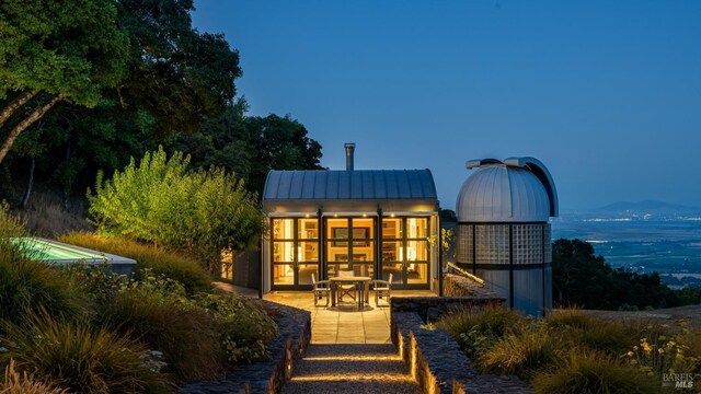 back of property with a standing seam roof and metal roof