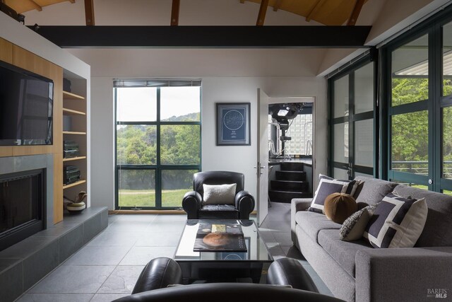 living room featuring vaulted ceiling with beams